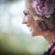 Blond woman with a pink flower smiling