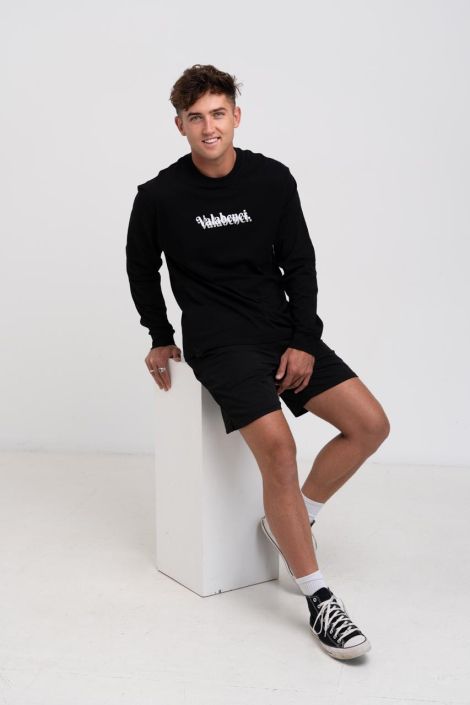 Fashion Photographer North Shore Sitting Man wearing a black outfit