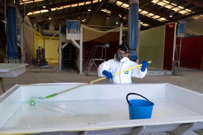 Commercial Photography Auckland Commercial staff photography for Transcold: Worker in protective mask and glovesWorker in protective mask and gloves in a factory