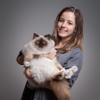 Girl holding a cat in the studio